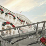 Intricate colonial-era detailing on the white facade of Raffles Hotel Singapore.