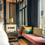 Artyzen Hotel room featuring colourful tones, comfortable seating, and large windows.