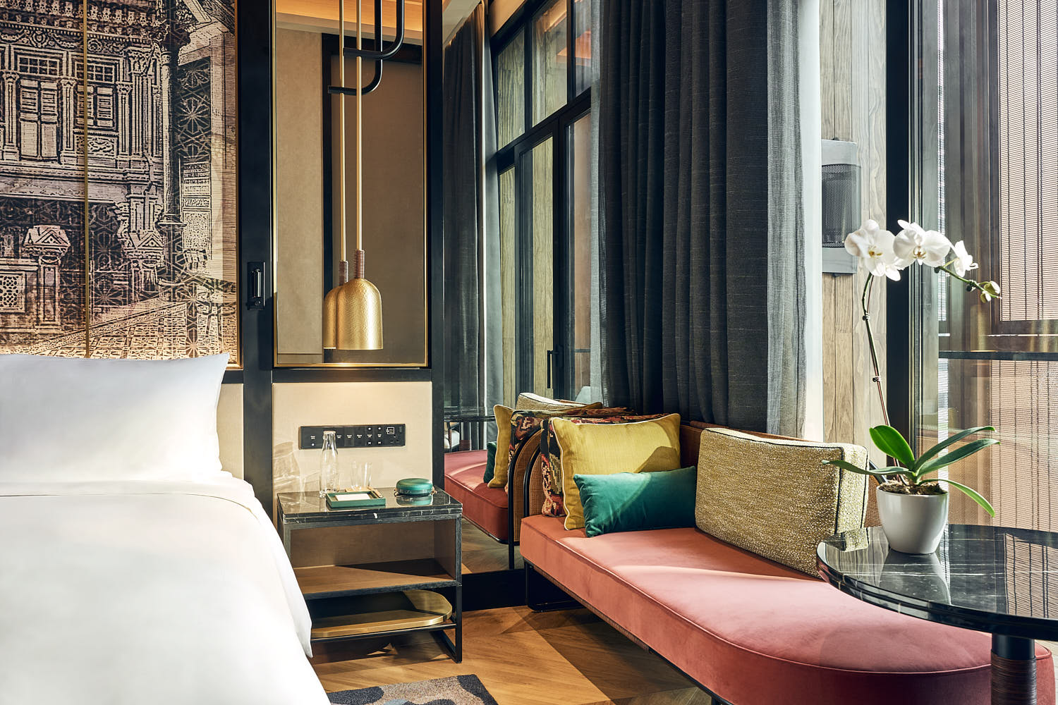 Artyzen Hotel room featuring colourful tones, comfortable seating, and large windows.