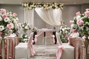 Intimate indoor solemnization setup at Novotel Hotel Singapore, with luxurious seating and delicate floral arrangements.