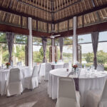 Banyan Tree Resort meeting room with sleek conference setup, natural light, overlooking lush greenery.
