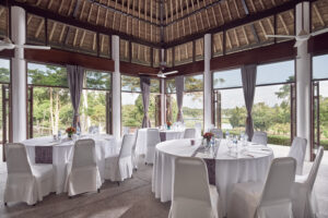 Banyan Tree Resort meeting room with sleek conference setup, natural light, overlooking lush greenery.