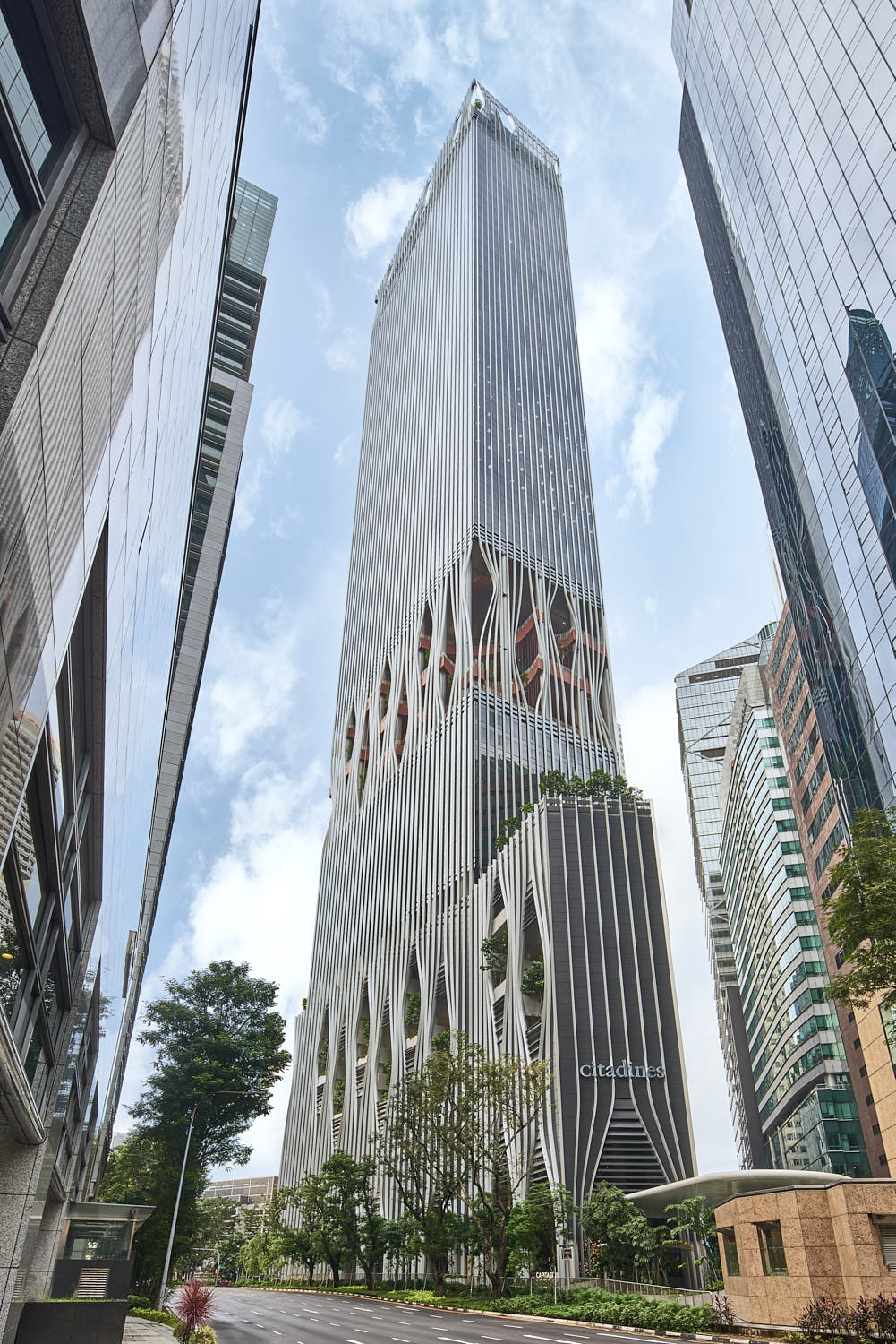 Grand high-rise structure of Citadines Raffles Place Singapore standing tall against the city skyline.