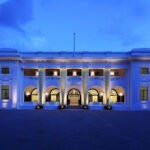 Stunning colonial architecture of Changi Cove Hotel Singapore illuminated in the soft glow of evening light.