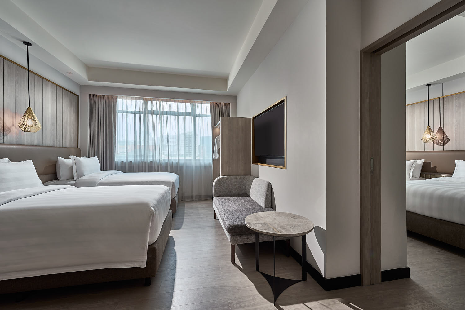 Spacious Novotel Singapore guest room with connecting room and modern minimalist decor.