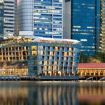 The Fullerton Bay Hotel’s striking waterfront architecture, blending modern design with serene water views.