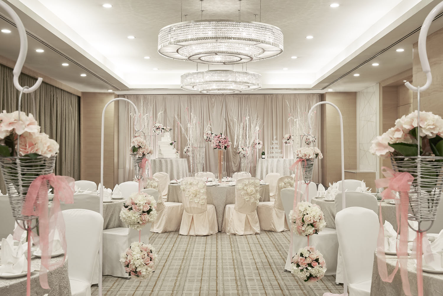 Hilton Hotel wedding reception venue featuring pastel decor, elegant seating, and glowing chandeliers.