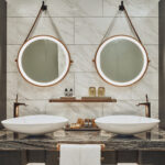 Spacious luxury bathroom at The Barracks Hotel, featuring marble countertops and gold accents.