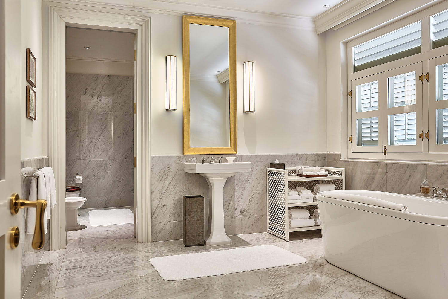 Opulent bathroom interior at Capella Hotel Singapore, with sleek marble surfaces and plush amenities.