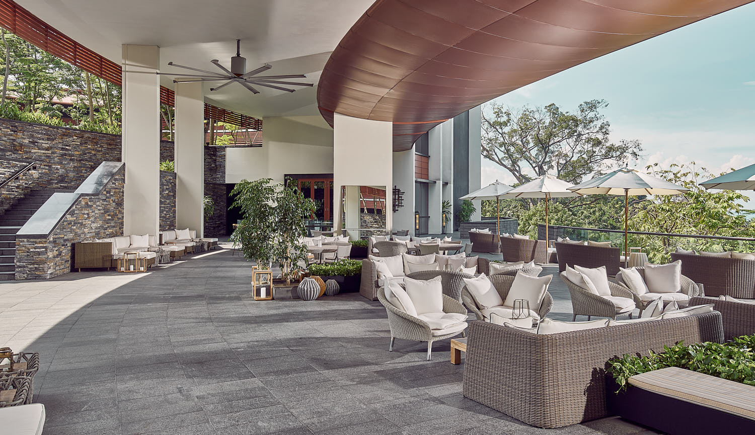 Capella Hotel Singapore's elegant architecture against a vibrant sky, showcasing classic design elements.