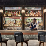 Rustic indoor bar at InterContinental Hotel with crafted cocktails.