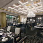 Upscale dining ambiance at Joel Robuchon restaurant with plush chairs and soft lighting.