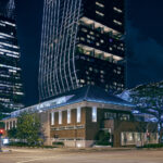 Illuminated facade of The NCO Club at JW Marriott Singapore, showcasing modern design and elegant lighting at night.