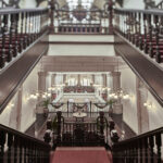 Classic interior staircase at Raffles Hotel Singapore, showcasing architectural elegance and vintage charm.