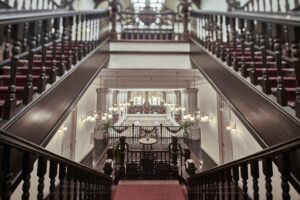 Classic interior staircase at Raffles Hotel Singapore, showcasing architectural elegance and vintage charm.