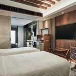 Warm and inviting hotel room at The Barracks, showcasing fine linens and tasteful decor.