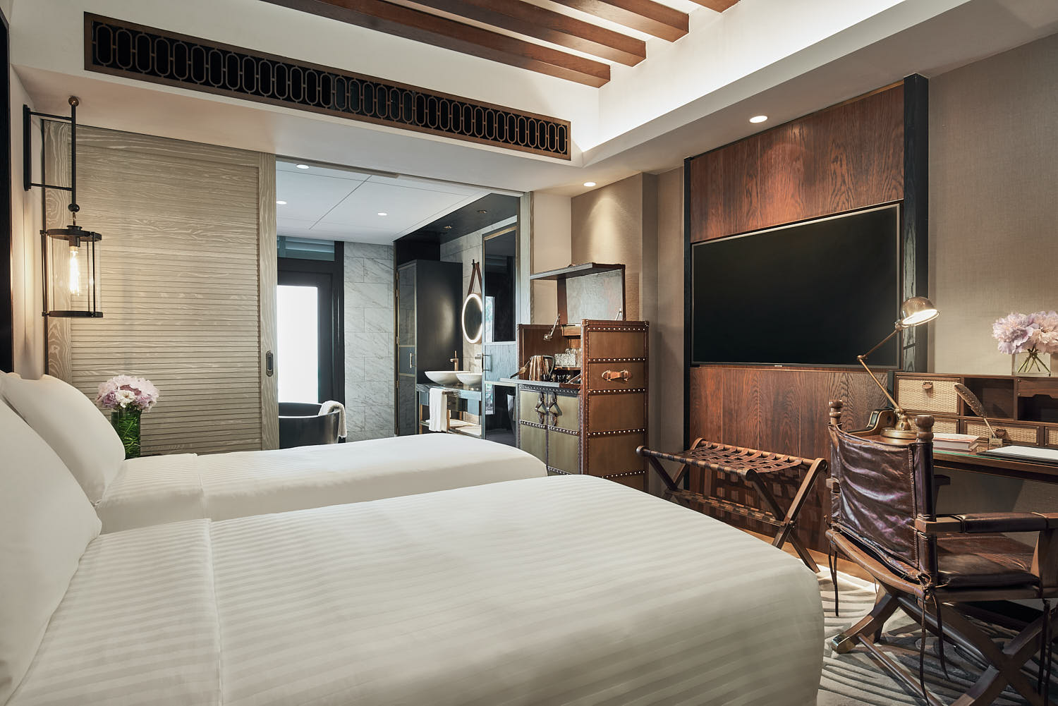 Warm and inviting hotel room at The Barracks, showcasing fine linens and tasteful decor.