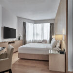 Comfortable guest room at Marriott Singapore featuring contemporary furnishings and a cozy atmosphere.