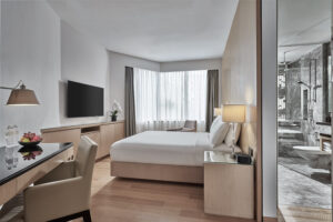 Comfortable guest room at Marriott Singapore featuring contemporary furnishings and a cozy atmosphere.