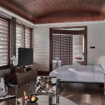 Marriott hotel room with stylish furnishings and natural light streaming through large windows.