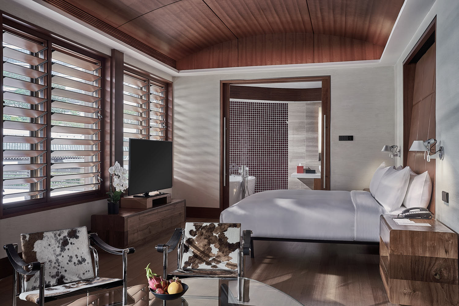 Marriott hotel room with stylish furnishings and natural light streaming through large windows.