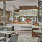 Marriott hotel restaurant with open kitchen concept, luxurious seating, and ambient atmosphere.