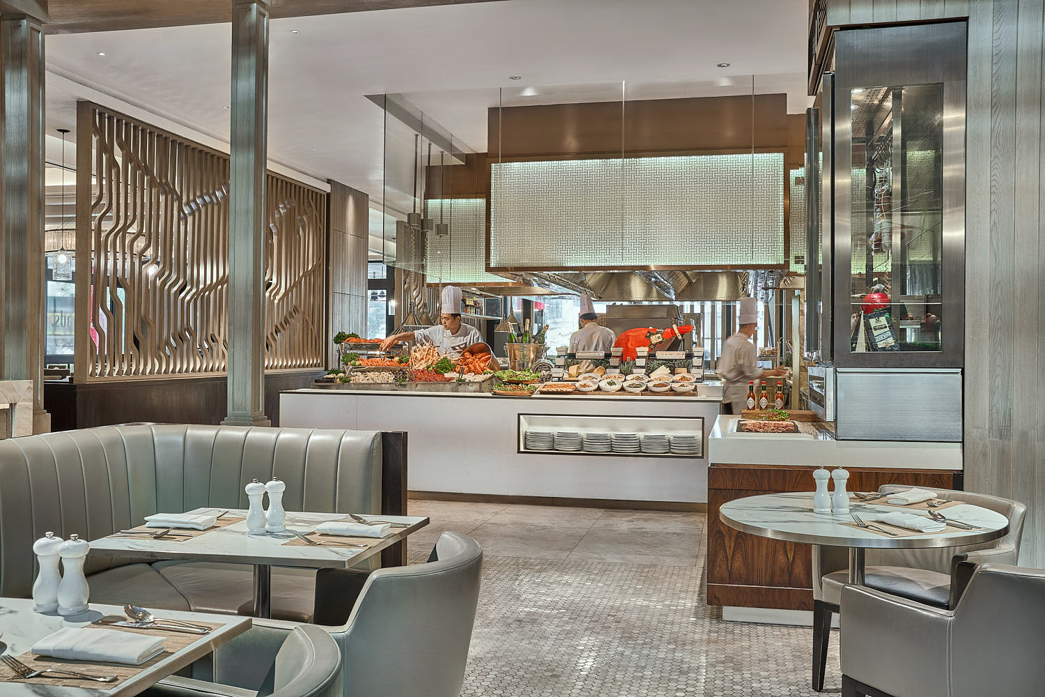 Marriott hotel restaurant with open kitchen concept, luxurious seating, and ambient atmosphere.