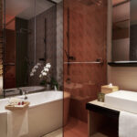 Stylish bathroom with a luxurious bathtub at Oasia Hotel, offering a contemporary, open layout.