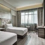 Cozy twin-bedded room at Novotel Singapore with sleek furnishings and a relaxing atmosphere.