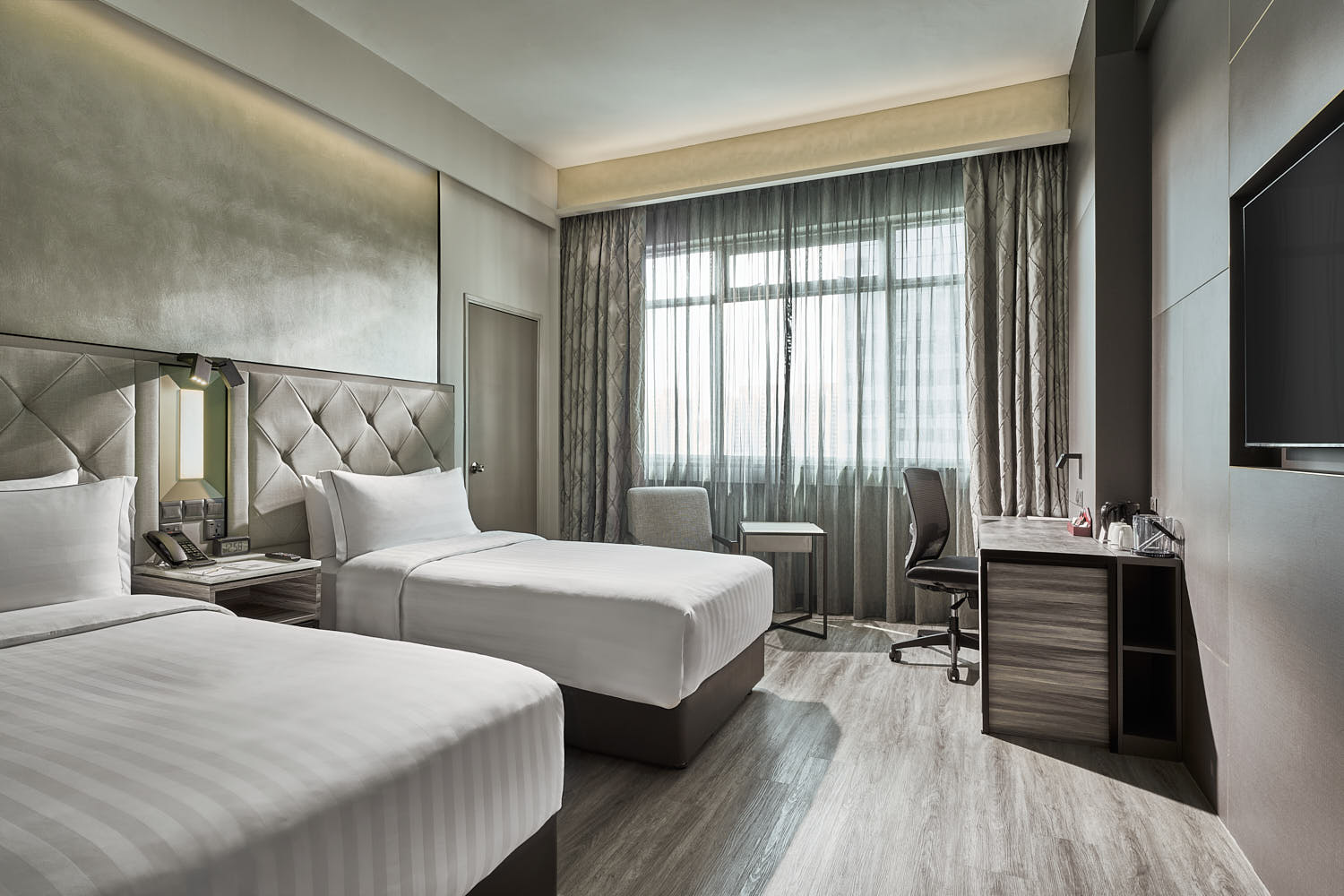 Cozy twin-bedded room at Novotel Singapore with sleek furnishings and a relaxing atmosphere.