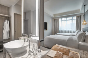Contemporary bathroom in Novotel Singapore room with a glass-enclosed shower and modern fixtures.