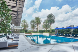 Novotel hotel's elevated swimming pool with lush greenery and contemporary design elements.