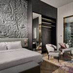 Opulent hotel room at One Farrer Hotel, featuring a spacious sitting area and sophisticated design elements.
