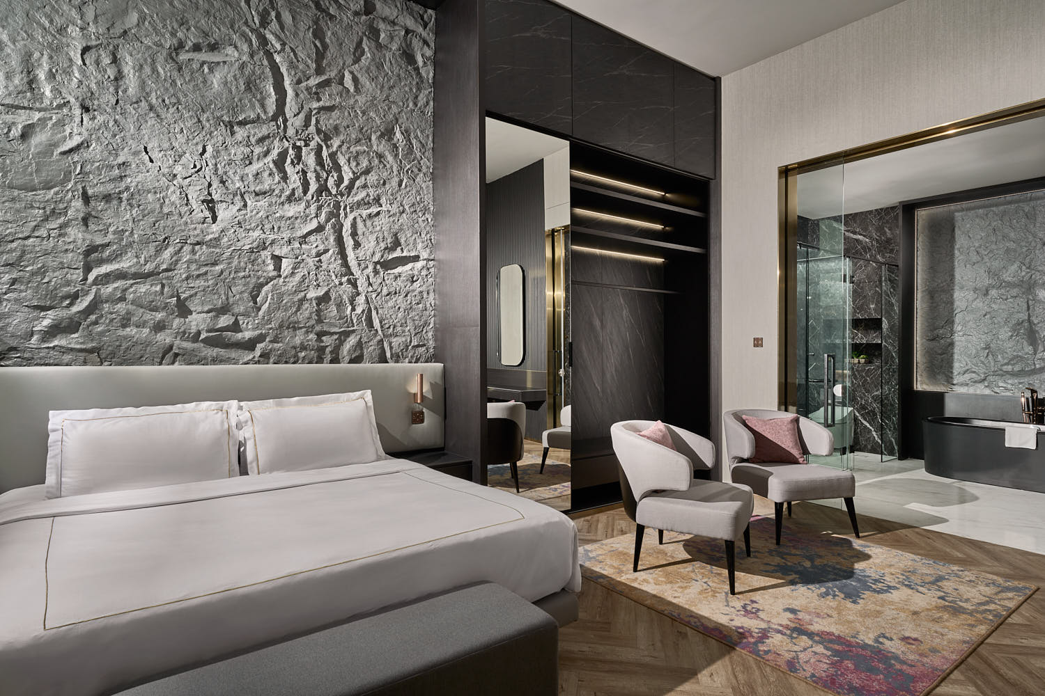 Opulent hotel room at One Farrer Hotel, featuring a spacious sitting area and sophisticated design elements.