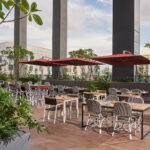 Spacious terrace at Holiday Inn, ideal for events, surrounded by tropical gardens and modern decor.