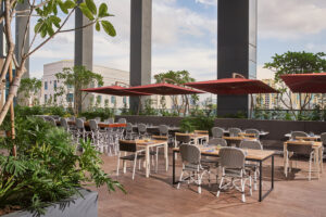 Spacious terrace at Holiday Inn, ideal for events, surrounded by tropical gardens and modern decor.