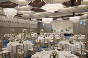 Pan Pacific Hotel indoor wedding setup with plush seating, chandeliers, and an elegant floral arrangements.