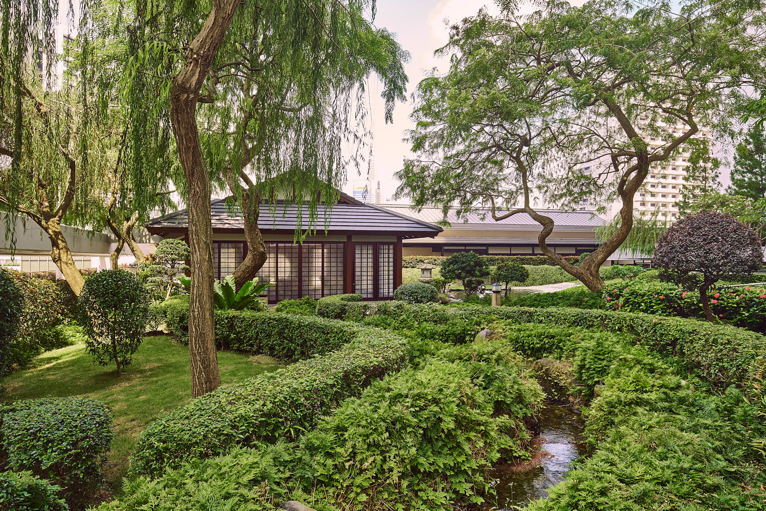Serene landscaped garden with water features at Pan Pacific Hotel Singapore.