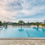 Relaxing poolside at PARKROYAL, offering a serene environment with expansive city views.