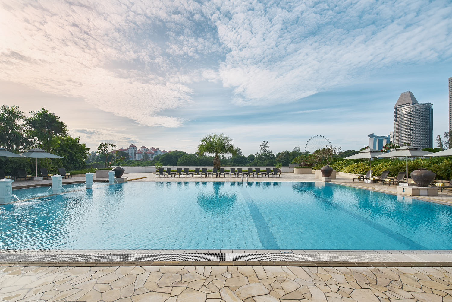 Relaxing poolside at PARKROYAL, offering a serene environment with expansive city views.