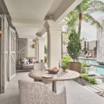 Room foyer at The Barracks Sentosa, featuring a cozy breakfast setup with a view of the serene pool.