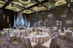 PARKROYAL Hotel Singapore’s ballroom wedding setup, showcasing tall floral arrangements, crystal candelabras, and refined table settings.