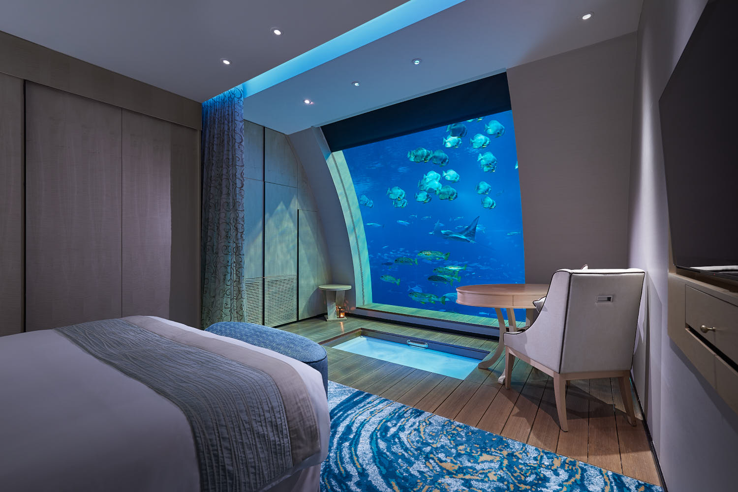 Ocean Suites Hotel at RWS showcasing vibrant marine life and colorful fish from room.