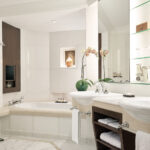 Luxurious bathroom retreat at Shangri La Hotel, featuring intricate tile work, premium fixtures, and a soothing atmosphere.