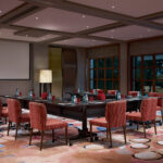 Sofitel Resort meeting room with collaborative workspace and comfortable chairs.