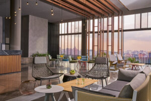 Modern hotel reception area with open-concept design and city skyline at Oasia Downtown.
