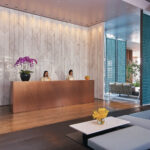 Oasia Downtown lobby with modern furnishings, high ceilings, and artful design.