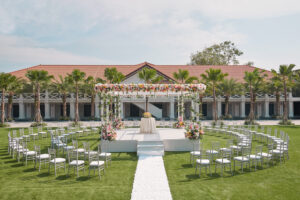 Romantic grand wedding setup at The Barracks Hotel, complete with a flower-lined aisle and vibrant colors.