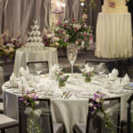 Close-up of a luxurious wedding VIP table at Hilton Hotel Singapore, featuring elegant floral arrangements and fine china.
