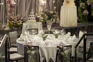 Close-up of a luxurious wedding VIP table at Hilton Hotel Singapore, featuring elegant floral arrangements and fine china.